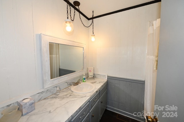 bathroom featuring vanity and wooden walls