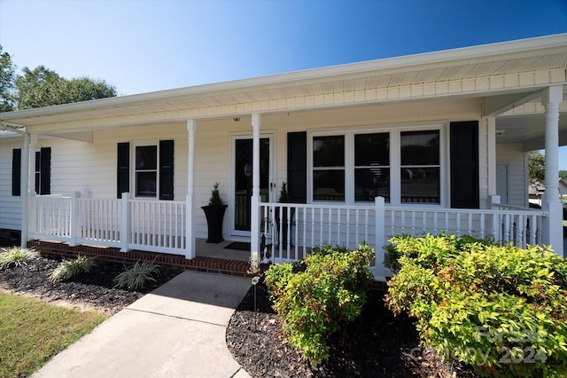 doorway to property featuring covered porch