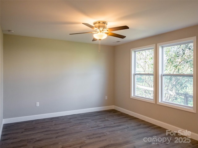 empty room featuring dark hardwood / wood-style floors and ceiling fan