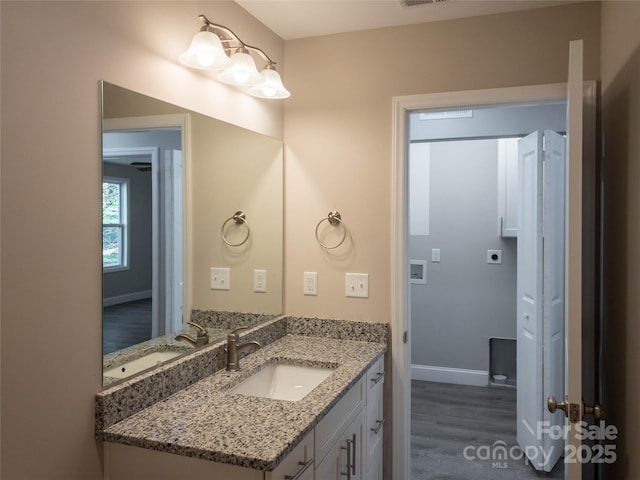 bathroom with vanity and hardwood / wood-style flooring