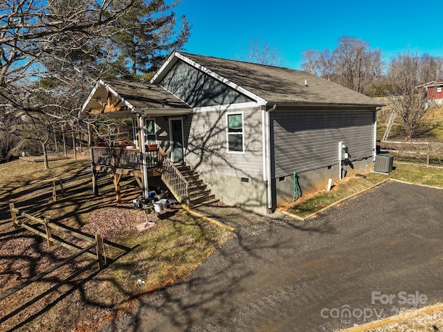 view of front of property featuring a wooden deck and cooling unit