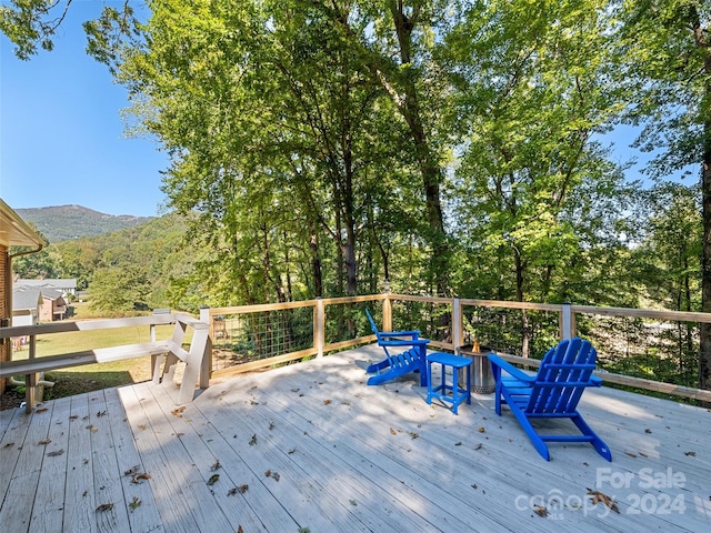 wooden deck with a mountain view