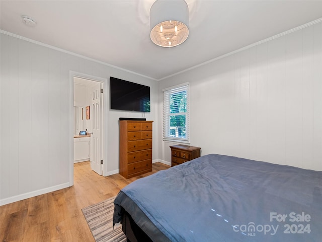 bedroom featuring wood-type flooring and crown molding