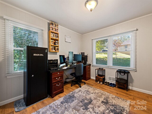 office space featuring light hardwood / wood-style flooring and crown molding