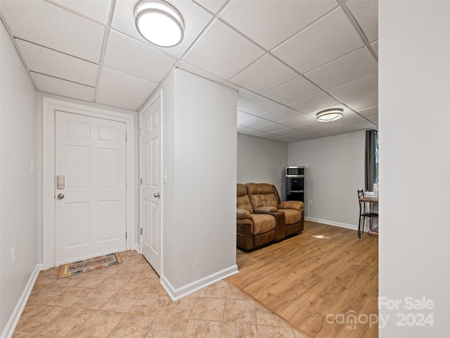 entrance foyer featuring a drop ceiling and light wood-type flooring