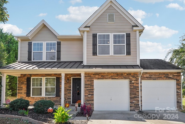 view of front of property featuring covered porch and a garage