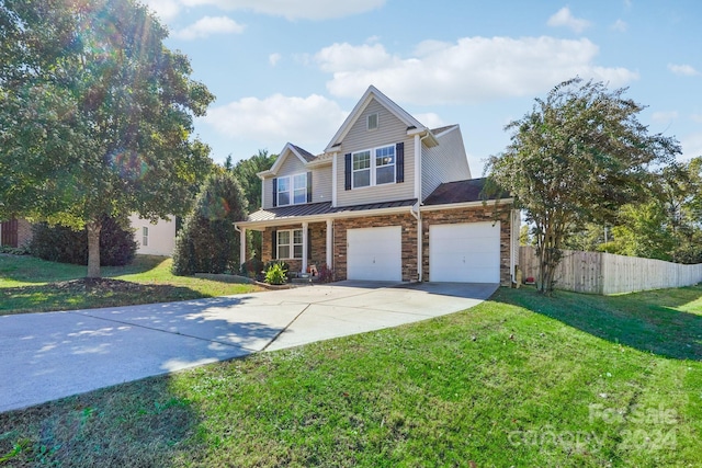 view of front of house with a garage and a front yard