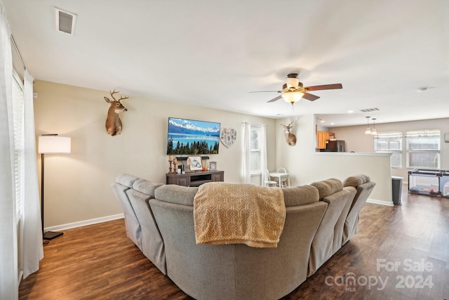 living room with ceiling fan and dark hardwood / wood-style floors