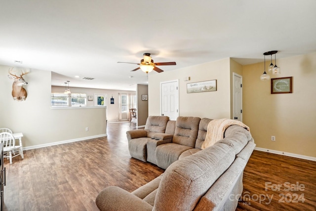 living room with ceiling fan and dark hardwood / wood-style flooring