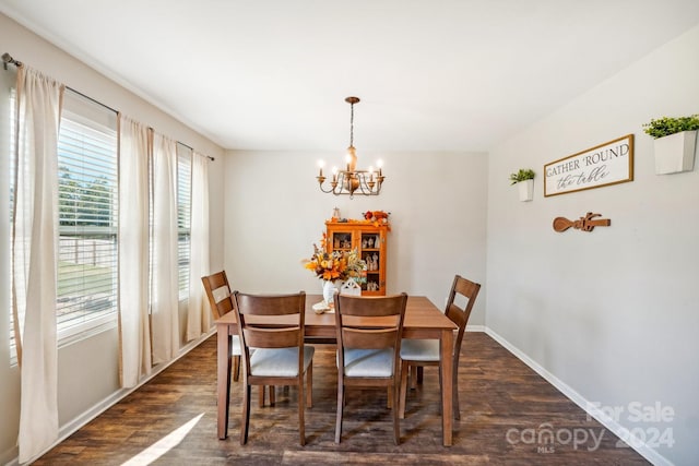 dining space featuring an inviting chandelier and dark hardwood / wood-style floors