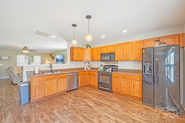 kitchen featuring ceiling fan, sink, light hardwood / wood-style flooring, decorative light fixtures, and black appliances