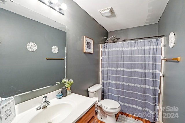 bathroom featuring vanity, toilet, and a shower with shower curtain