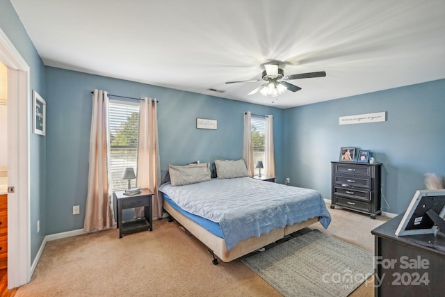 bedroom with ceiling fan and light colored carpet