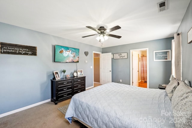 bedroom with light colored carpet, ensuite bathroom, and ceiling fan