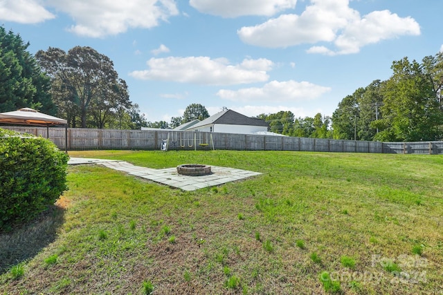 view of yard with a patio and a fire pit