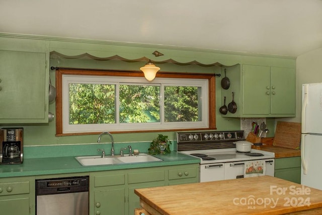 kitchen with green cabinetry, sink, and white appliances