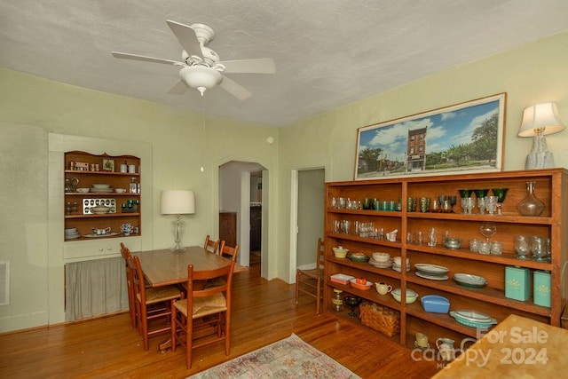 dining area with hardwood / wood-style floors and ceiling fan