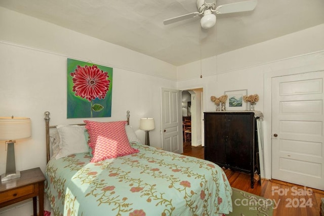 bedroom featuring ceiling fan and dark wood-type flooring