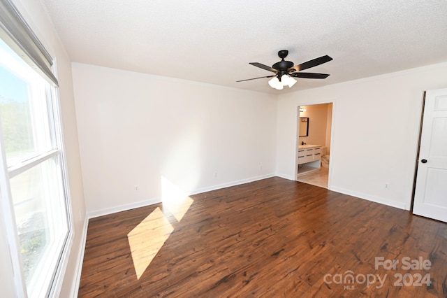 unfurnished room featuring dark hardwood / wood-style floors, crown molding, a textured ceiling, and ceiling fan