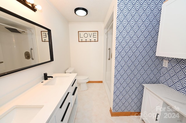 bathroom with vanity, tile patterned floors, toilet, a shower, and a textured ceiling