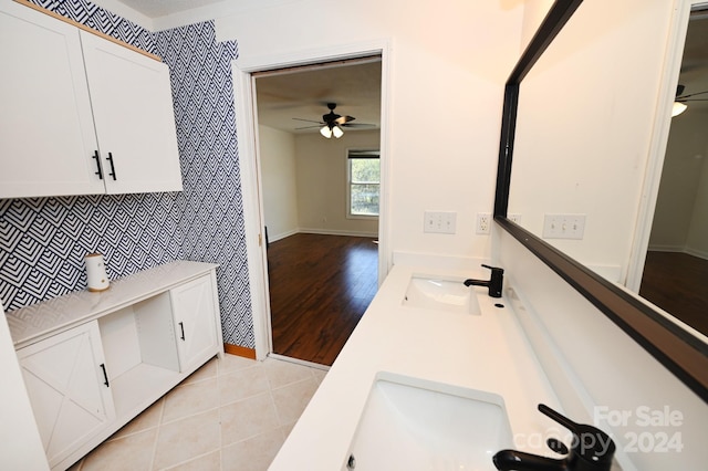 bathroom featuring wood-type flooring, vanity, and ceiling fan