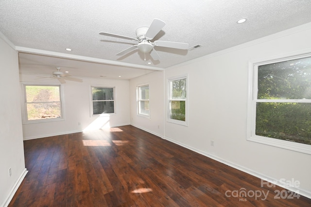 empty room with ceiling fan, dark hardwood / wood-style floors, and a textured ceiling