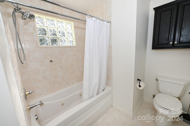 bathroom with tile patterned floors, shower / bath combo with shower curtain, and toilet