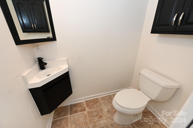 bathroom with toilet and vanity