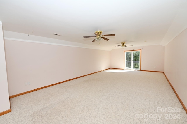 spare room featuring light carpet and ceiling fan