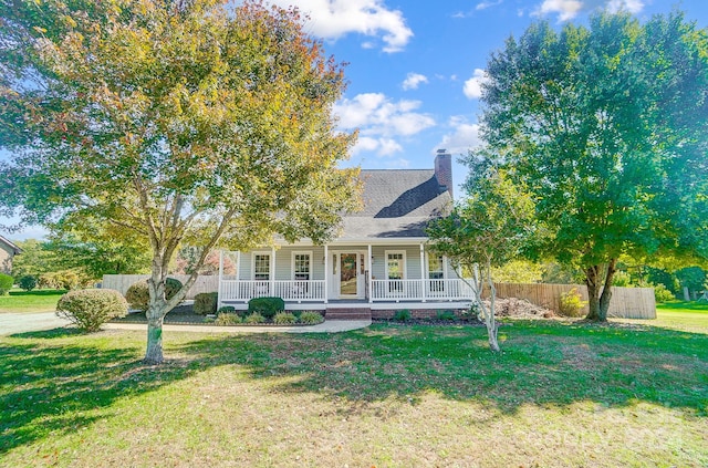 view of front of house with a front yard and a porch