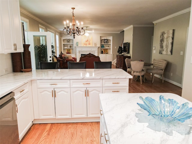 kitchen with dishwasher, white cabinets, light stone countertops, decorative light fixtures, and light hardwood / wood-style floors