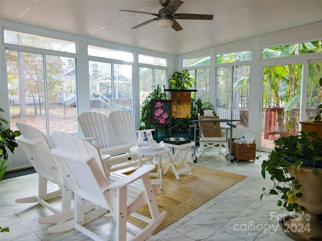 sunroom featuring ceiling fan and a healthy amount of sunlight