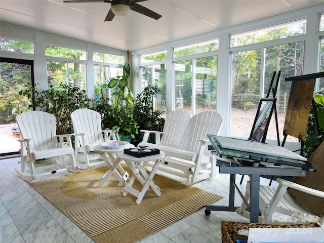 sunroom featuring ceiling fan