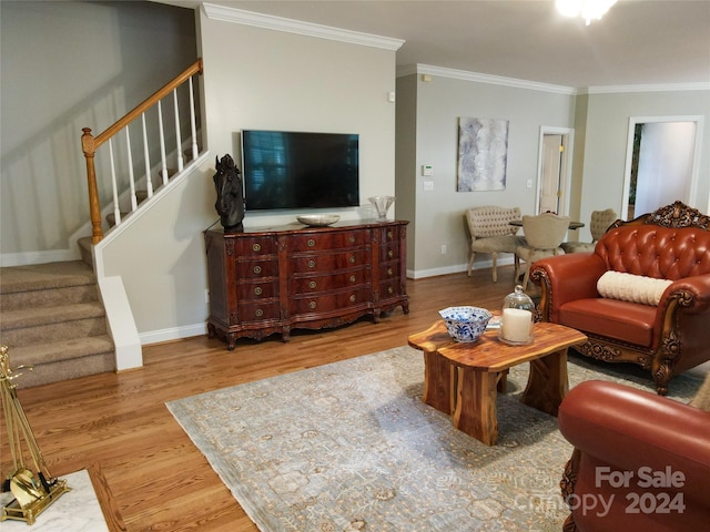 living room featuring crown molding and hardwood / wood-style flooring