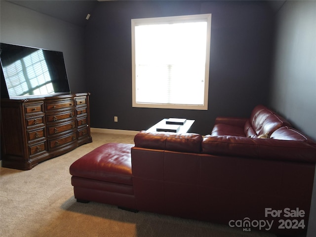 living room with light colored carpet and lofted ceiling