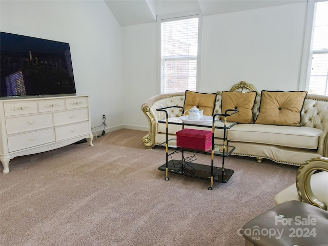 living room with light colored carpet and vaulted ceiling