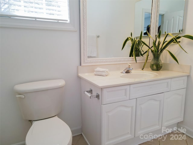 bathroom featuring tile patterned floors, vanity, and toilet