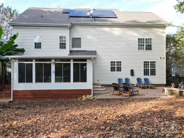 back of house with a patio area and a sunroom