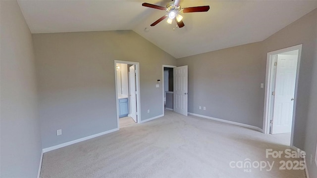 8403 Spirea Ct, Charlotte, NC 28215 - unfurnished bedroom with lofted ceiling, ensuite bath, a ceiling fan, baseboards, and light colored carpet