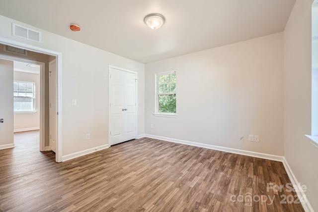 unfurnished bedroom featuring a closet and wood-type flooring