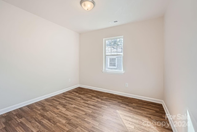 empty room with hardwood / wood-style flooring