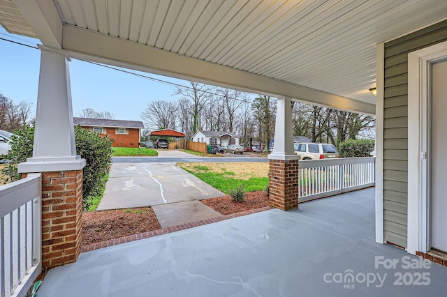 view of patio featuring a residential view and covered porch