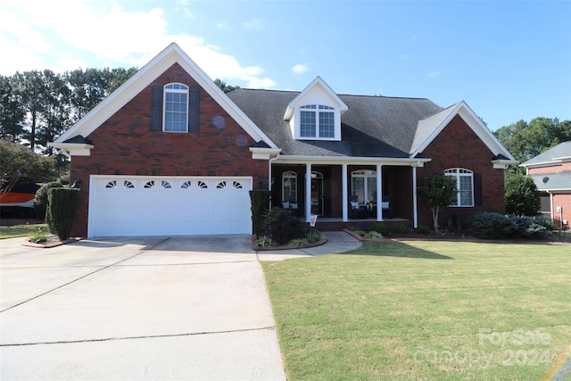 view of front of property featuring a garage and a front lawn