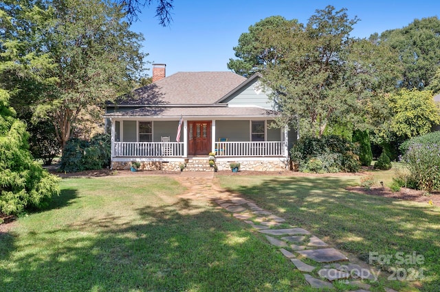 view of front of house with a front yard and covered porch