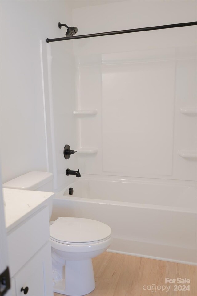 full bathroom featuring shower / bath combination, hardwood / wood-style flooring, vanity, and toilet