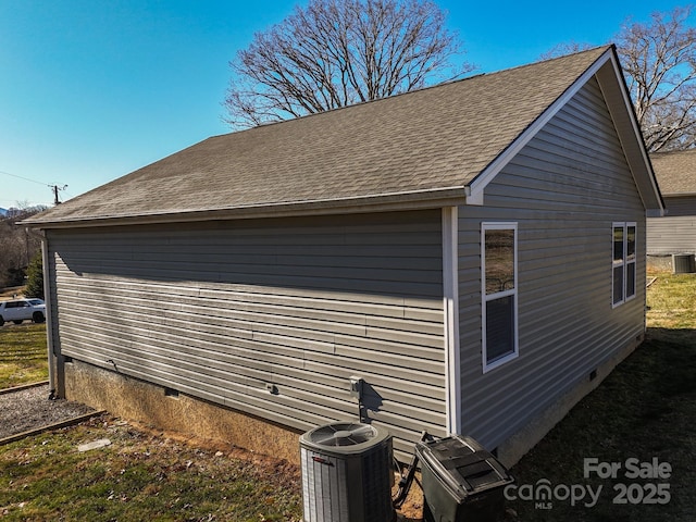 view of side of home featuring cooling unit