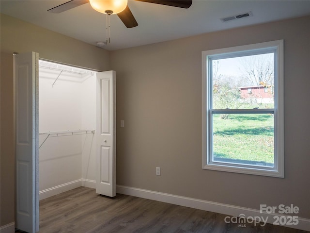 unfurnished bedroom featuring hardwood / wood-style floors and ceiling fan