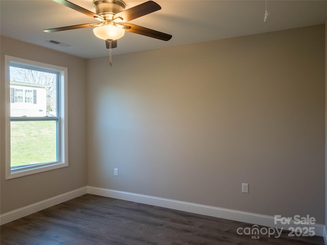 unfurnished room featuring ceiling fan and dark hardwood / wood-style flooring