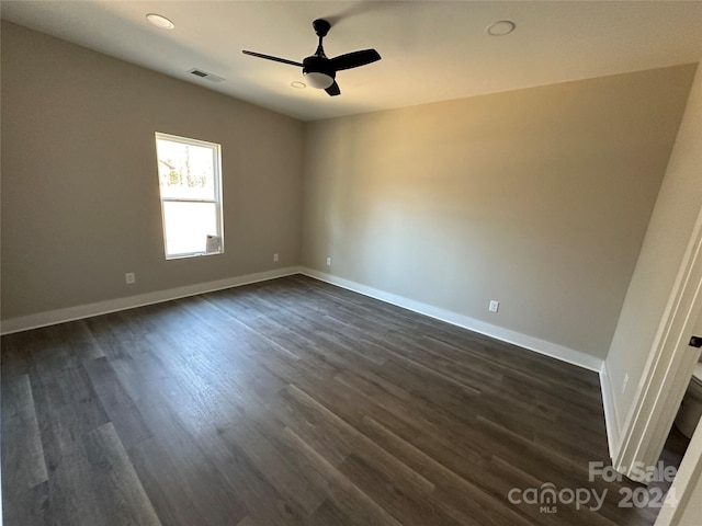 spare room with ceiling fan and dark wood-type flooring