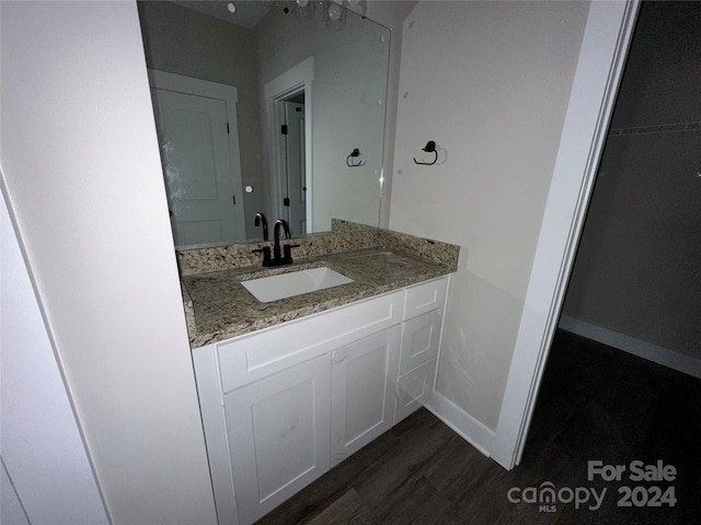 bathroom featuring vanity and hardwood / wood-style flooring